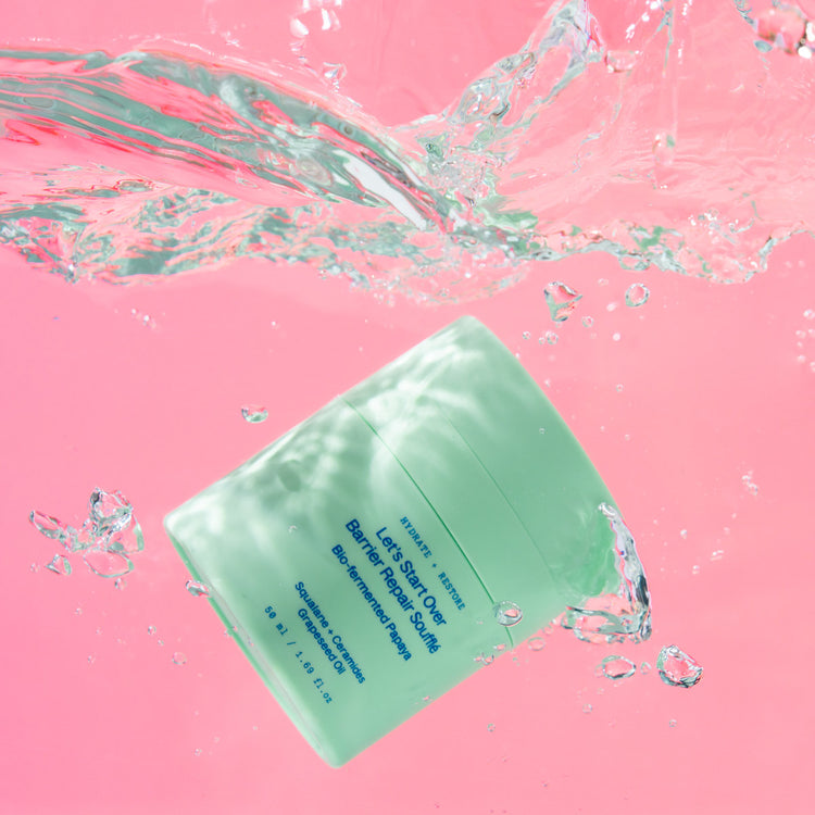Let's Start Over Barrier Repair Soufflé, splashing into water on a pink ground