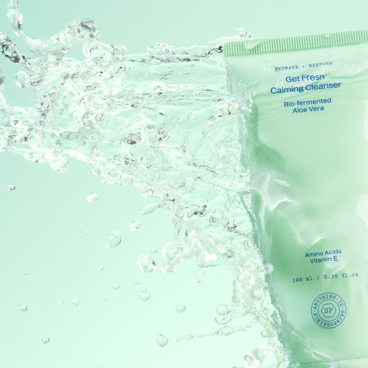 Get Fresh Calming Cleanser tube with water splashing across it against a mint green background